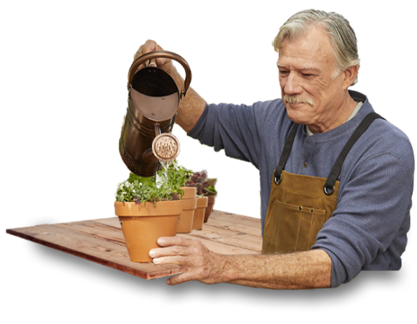 Man in garden watering potted plants